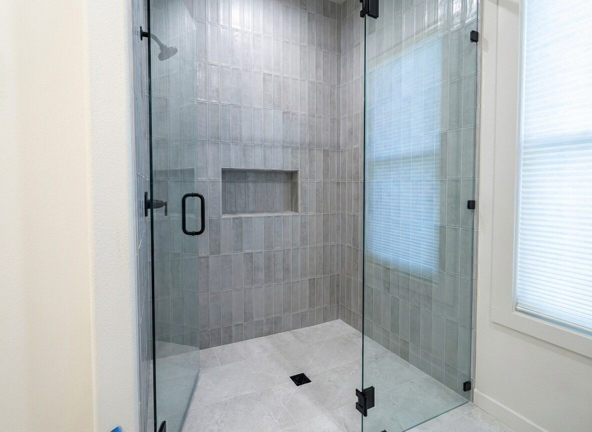 Modern glass-enclosed tile shower installed by BM Pro Construction
